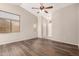 Cozy living room featuring stylish wood flooring and a ceiling fan at 30601 N Royal Oak Way, San Tan Valley, AZ 85143