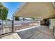 Wide backyard with covered patio, decorative rock, and block fence at 3307 E Kings Ave, Phoenix, AZ 85032