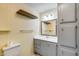 Small bathroom with built-in storage, shelf, vanity, and toilet at 3307 E Kings Ave, Phoenix, AZ 85032