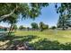 Expansive green lawn with mature trees, a scenic pond, and recreational amenities in the community at 3307 E Kings Ave, Phoenix, AZ 85032