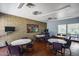 Spacious game room featuring tables, chairs, brick accent wall, and game machines, perfect for entertainment and relaxation at 3307 E Kings Ave, Phoenix, AZ 85032