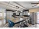 Modern kitchen features an island with seating, stainless steel appliances, and stylish gray cabinetry at 3307 E Kings Ave, Phoenix, AZ 85032