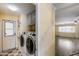 Laundry room includes washer, dryer, and storage cabinets with a view into the main house at 3307 E Kings Ave, Phoenix, AZ 85032