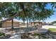 Community picnic area with picnic tables, a barbecue grill, and shade structures under mature trees at 3307 E Kings Ave, Phoenix, AZ 85032