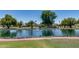 Picturesque view of a serene pond with a fountain, surrounded by well-manicured landscaping and lush greenery at 3307 E Kings Ave, Phoenix, AZ 85032