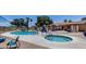 Relaxing pool and hot tub area with ample seating, shade structures, and a building in the background at 3307 E Kings Ave, Phoenix, AZ 85032