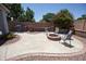 Inviting backyard with a built-in grill, seating, and charming fire pit, perfect for outdoor entertaining at 3314 E Page Ave, Gilbert, AZ 85234