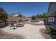 Beautiful backyard featuring a fire pit, seating, and a pool surrounded by lush landscaping for relaxation at 3314 E Page Ave, Gilbert, AZ 85234