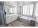 Bathroom showcasing a bathtub, tile accents, and double sink at 3314 E Page Ave, Gilbert, AZ 85234
