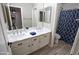 Bathroom featuring double sinks, wood-style floors, and a shower with a patterned curtain at 3314 E Page Ave, Gilbert, AZ 85234