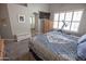 Neutral bedroom with large windows, mounted TV, and an en suite bathroom at 3314 E Page Ave, Gilbert, AZ 85234