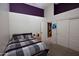 Bright bedroom featuring purple accent wall, double closets, and neutral carpet at 3314 E Page Ave, Gilbert, AZ 85234