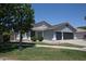 Charming single-story home with a well-manicured lawn, mature trees, and a three car garage at 3314 E Page Ave, Gilbert, AZ 85234
