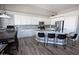 Beautiful kitchen with white cabinets, granite countertops, bar seating, and a stainless steel refrigerator at 3314 E Page Ave, Gilbert, AZ 85234