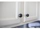 Close-up view of white kitchen cabinets with sleek, dark hardware at 3314 E Page Ave, Gilbert, AZ 85234