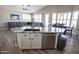 Modern kitchen with a large island, stainless steel appliances, an open layout, and adjacent living and dining spaces at 3314 E Page Ave, Gilbert, AZ 85234