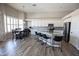 Bright kitchen featuring white cabinets, modern appliances, an island with bar seating, and an adjacent dining area at 3314 E Page Ave, Gilbert, AZ 85234