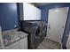 Modern laundry room with front loading washer and dryer and granite countertops at 3314 E Page Ave, Gilbert, AZ 85234