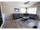 Inviting living room with a cozy sectional sofa and elegant area rug at 3314 E Page Ave, Gilbert, AZ 85234