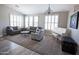 Comfortable living room featuring a white piano, elegant decor, and neutral tones with lots of light from the windows at 3314 E Page Ave, Gilbert, AZ 85234