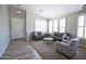 Bright and airy living room featuring neutral tones, stylish furniture, and ample natural light from the windows at 3314 E Page Ave, Gilbert, AZ 85234
