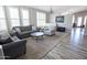 Spacious living room with stylish sofas, a patterned chair, and wood-look floors for comfortable modern living at 3314 E Page Ave, Gilbert, AZ 85234