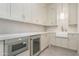 Cozy kitchen space with modern appliances, white cabinetry, and a sink at 3506 N Crystal Peak Cir, Mesa, AZ 85207