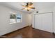 Standard sized bedroom with a ceiling fan and closet at 3814 E Poinsettia Dr, Phoenix, AZ 85028