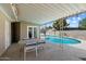 Covered patio area with table and chairs next to refreshing backyard pool at 3814 E Poinsettia Dr, Phoenix, AZ 85028