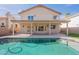 Spacious backyard featuring a refreshing pool, a large balcony, and a covered patio at 3837 E Windsong Dr, Phoenix, AZ 85048