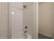Bathroom with a white tiled tub-shower combination and a brushed gold shower head at 3837 E Windsong Dr, Phoenix, AZ 85048