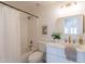 Stylish bathroom with a shower, tub, modern vanity, gold accents, and decorative artwork at 3837 E Windsong Dr, Phoenix, AZ 85048