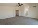 Spacious carpeted bedroom featuring an open doorway, closet, and ensuite bathroom at 3837 E Windsong Dr, Phoenix, AZ 85048
