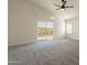 Bright bedroom with a ceiling fan, carpeted flooring, and sliding glass doors leading to a balcony at 3837 E Windsong Dr, Phoenix, AZ 85048