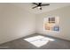 Bright bedroom featuring neutral walls, a ceiling fan, and a window with natural light at 3837 E Windsong Dr, Phoenix, AZ 85048