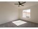 Bright bedroom featuring a ceiling fan and a window that lets in ample natural light at 3837 E Windsong Dr, Phoenix, AZ 85048