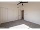 Carpeted bedroom with a double door closet and a single door leading to another room at 3837 E Windsong Dr, Phoenix, AZ 85048