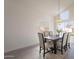 Dining room with a wooden table, comfortable chairs, and modern lighting fixture at 3837 E Windsong Dr, Phoenix, AZ 85048