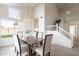 Bright dining area boasts modern lighting, a wooden table and six chairs, and large windows at 3837 E Windsong Dr, Phoenix, AZ 85048