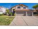 Inviting two-story home featuring a large three-car garage and well-maintained landscaping at 3837 E Windsong Dr, Phoenix, AZ 85048