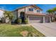 Charming two-story home with a well-manicured lawn and a spacious three-car garage at 3837 E Windsong Dr, Phoenix, AZ 85048
