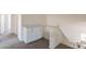 Hallway featuring carpet, cabinets with marble countertop, wooden handrail, and stairwell at 3837 E Windsong Dr, Phoenix, AZ 85048