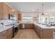 Spacious kitchen features stainless steel appliances, light countertops, and plenty of cabinet space at 3837 E Windsong Dr, Phoenix, AZ 85048