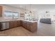 Open kitchen boasts modern cabinetry, stainless steel appliances, a large island, and breakfast bar at 3837 E Windsong Dr, Phoenix, AZ 85048