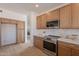 Modern kitchen with stainless steel appliances, custom cabinets, and spacious layout for entertaining at 3837 E Windsong Dr, Phoenix, AZ 85048