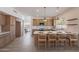 Stylish kitchen with center island, bar stool seating, stainless appliances, and adjacent dining area at 3837 E Windsong Dr, Phoenix, AZ 85048