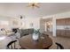 Open-concept living area with fireplace, wood-look tile flooring, and a view into the eat-in kitchen at 3837 E Windsong Dr, Phoenix, AZ 85048