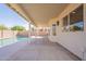 A covered patio offering a view of the pool and a glimpse of the home's interior lighting at 3837 E Windsong Dr, Phoenix, AZ 85048