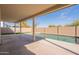 Covered patio overlooking the swimming pool with lush landscaping and a brick fence at 3837 E Windsong Dr, Phoenix, AZ 85048