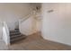 Inviting entryway with a wooden staircase, carpeted steps, and tile flooring at 3837 E Windsong Dr, Phoenix, AZ 85048